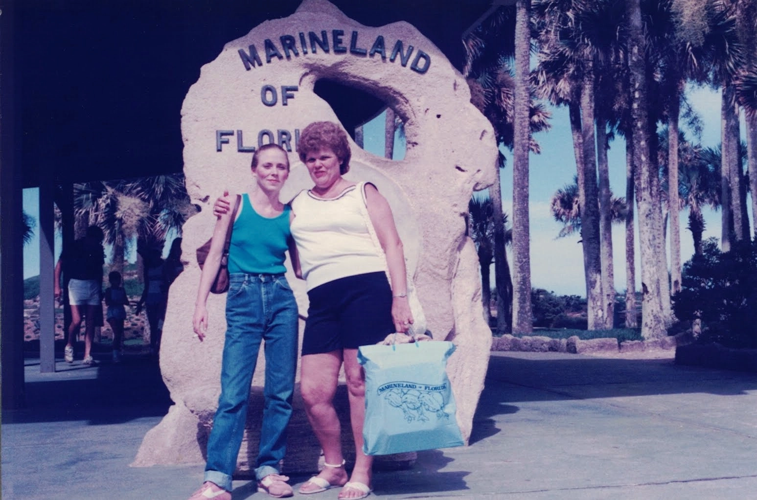 Mom and Grandma out front of the Marineland welcome rock, sometime in the 1980s. Palm trees litter the background.